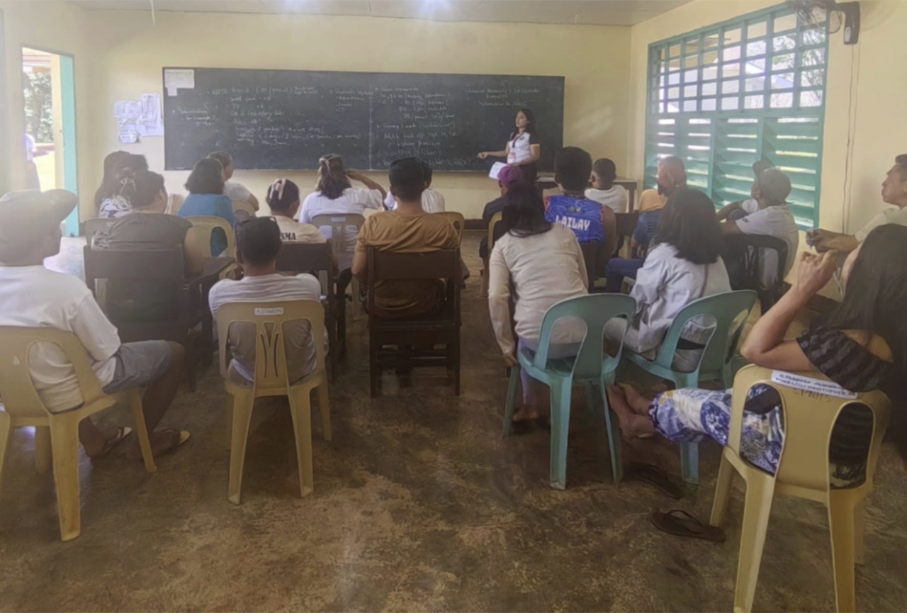 A facilitator teaching at the board during an ARISE workshop in the Philippines